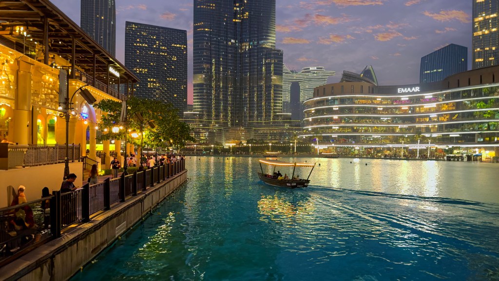 Join me on a humorous tour of Dubai Mall, where I explore its stunning interior design and mind-blowing spaces. From the sleek metro ride to the jaw-dropping Grand Atrium, luxury stores, a human waterfall, an ice rink in the desert, and even a real dinosaur skeleton, this mall has it all. 